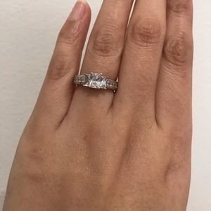 Silver emerald cut three stone engagement ring